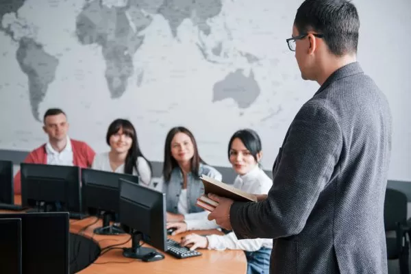 Business meeting with a man and woman discussing something on a tablet