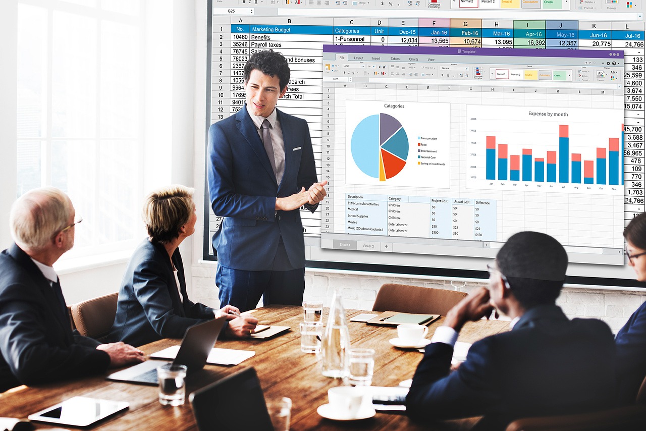 Business meeting with a man and woman discussing something on a tablet